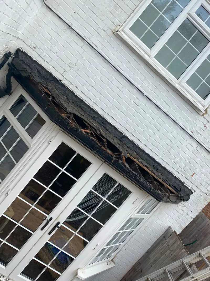 Rotten timber exposed on a bay window canopy before it was rebuilt