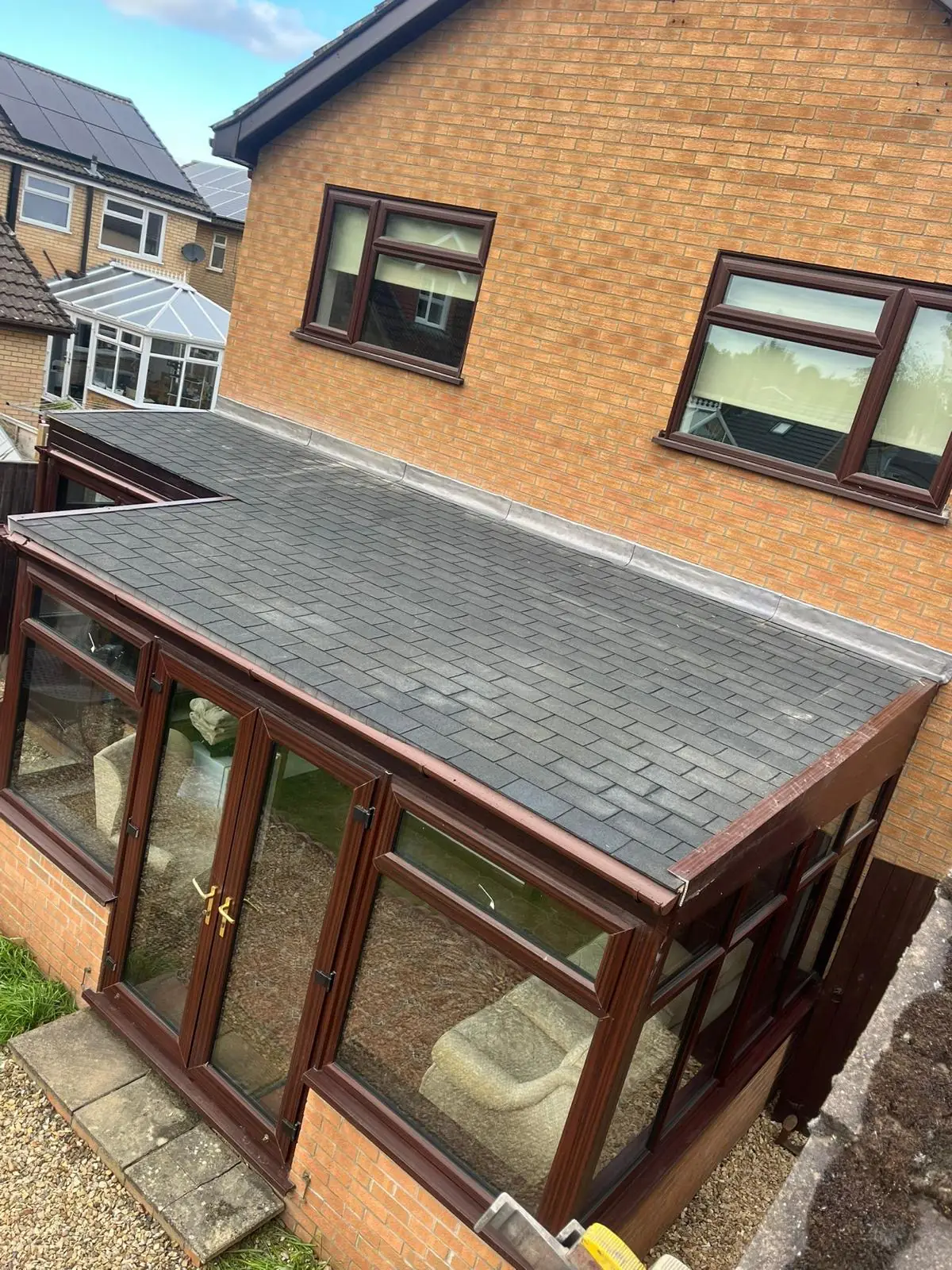The finished solid conservatory roof, tiled in grey