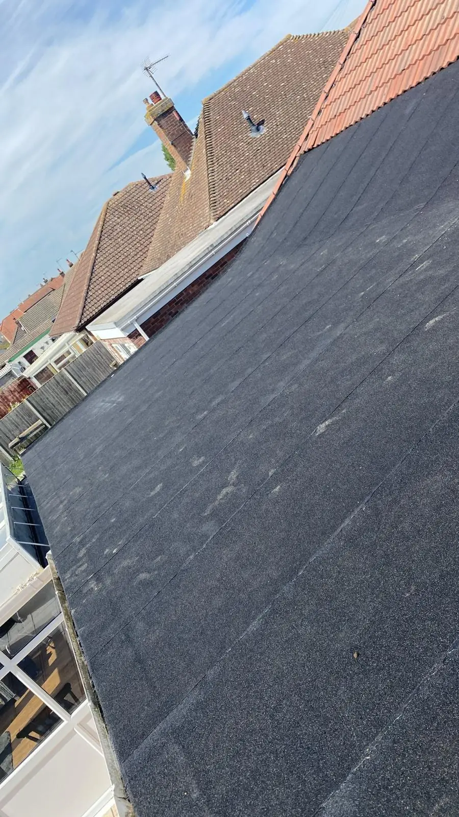 A flat roof running alongside a red pantile pitched roof