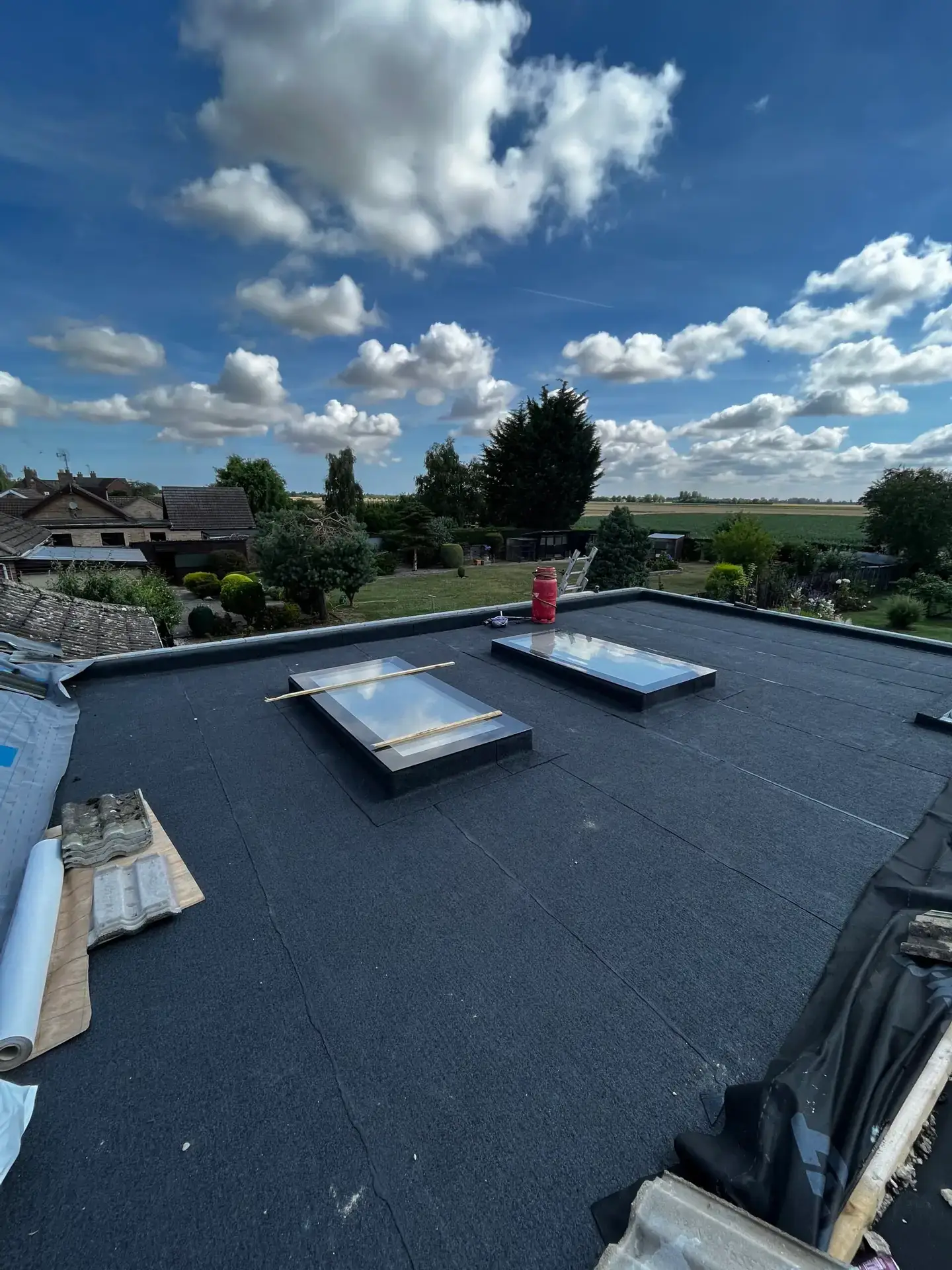 A large flat roof finished in felt with two rooflights fitted