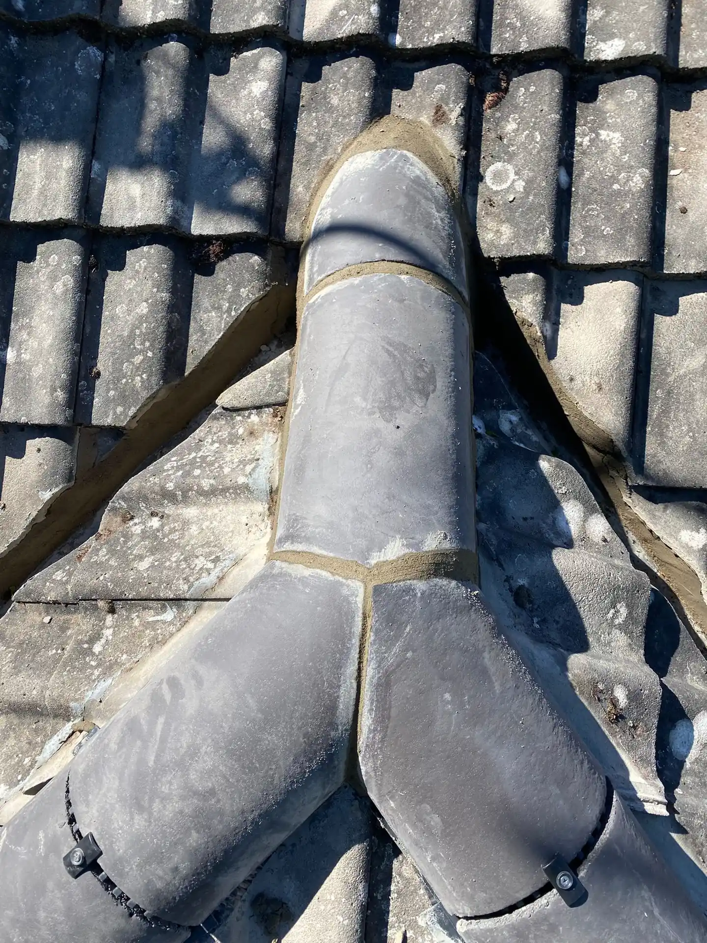 Lead dressed neatly around a soil vent pipe on a dark tiled roof