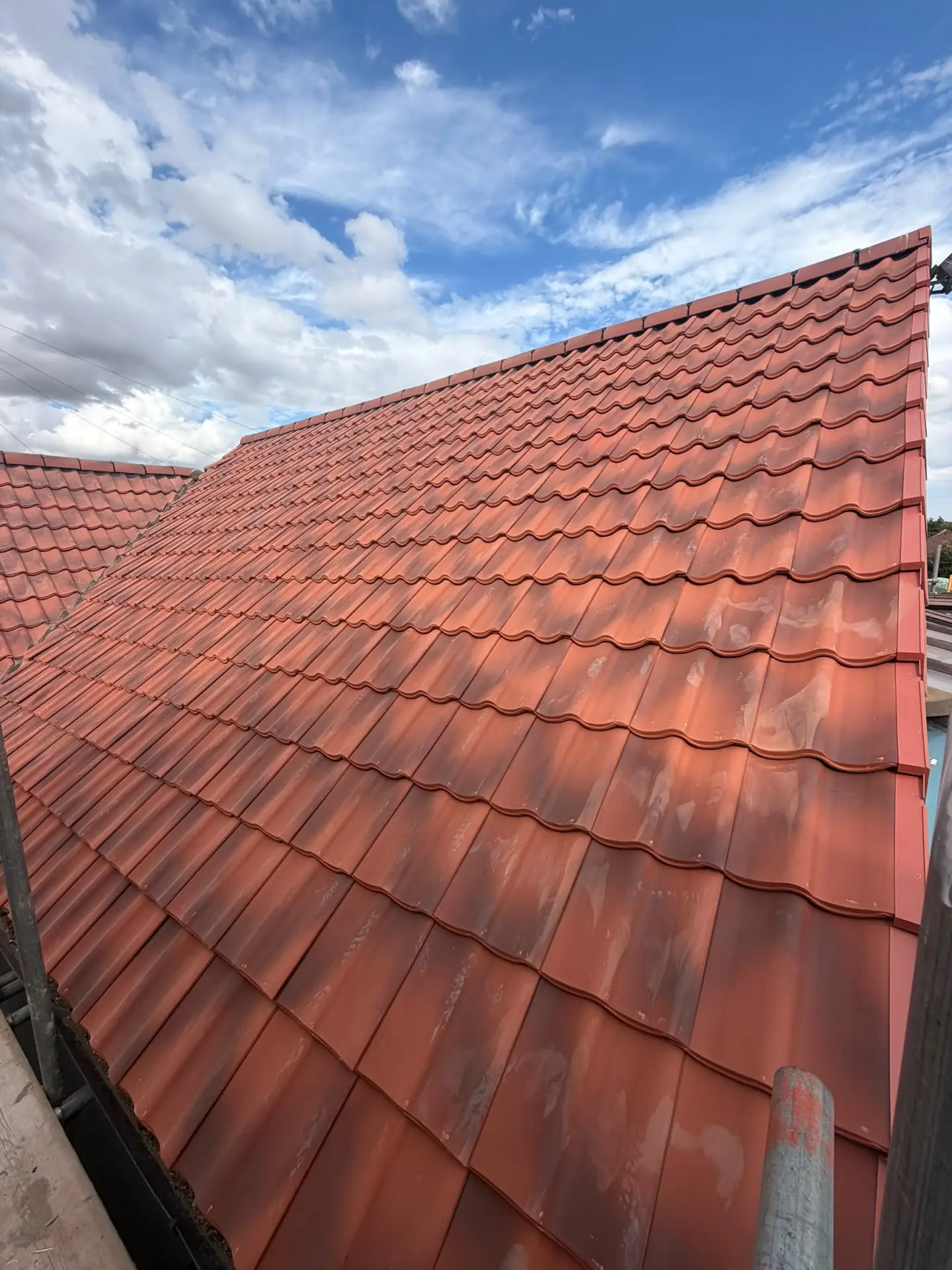 A completed red clay pantile roof photographed close up