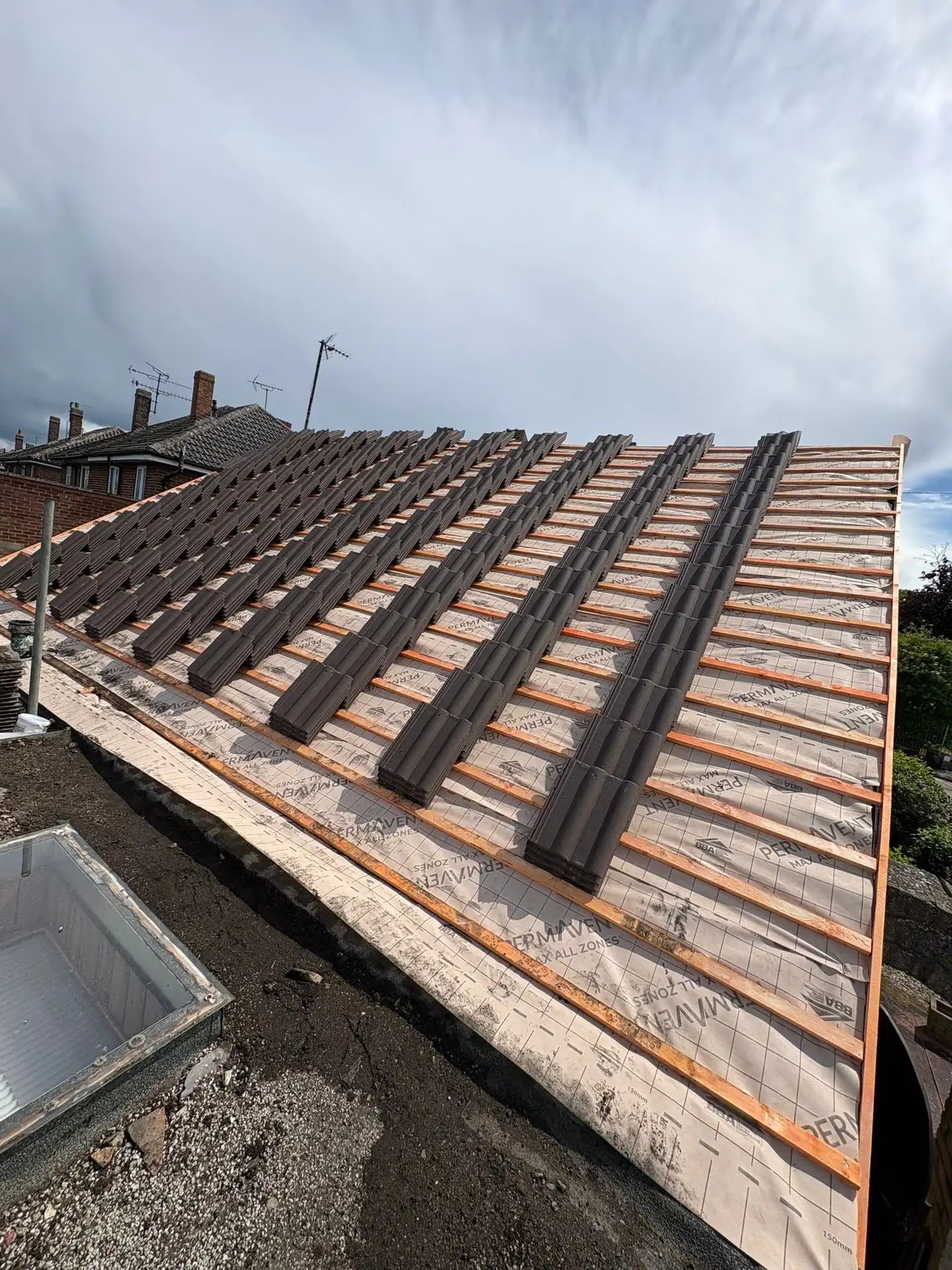 New battens fixed over breathable membrane, ready for tiling