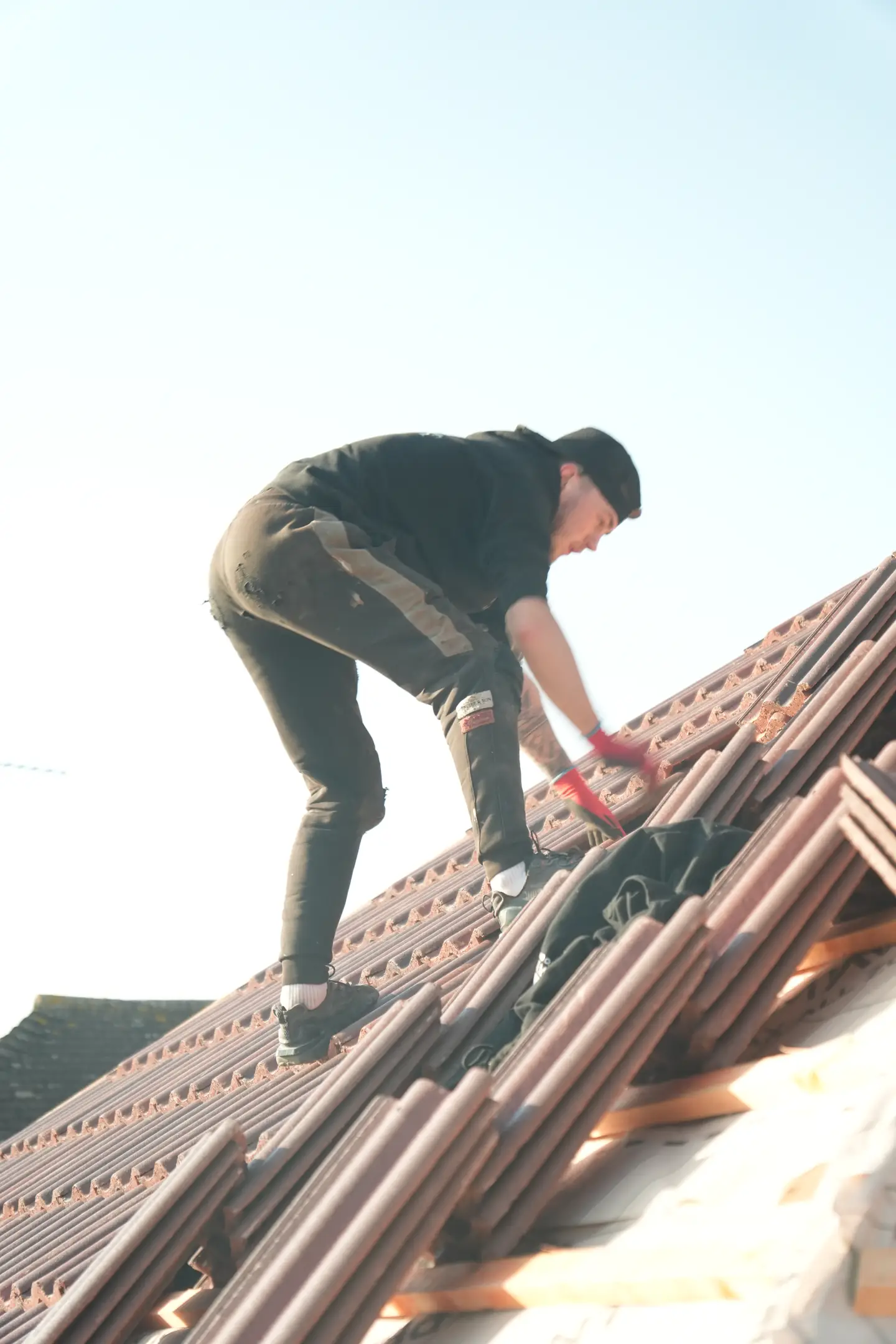 A Swift Roofing roofer laying red clay pantiles on a re-roof