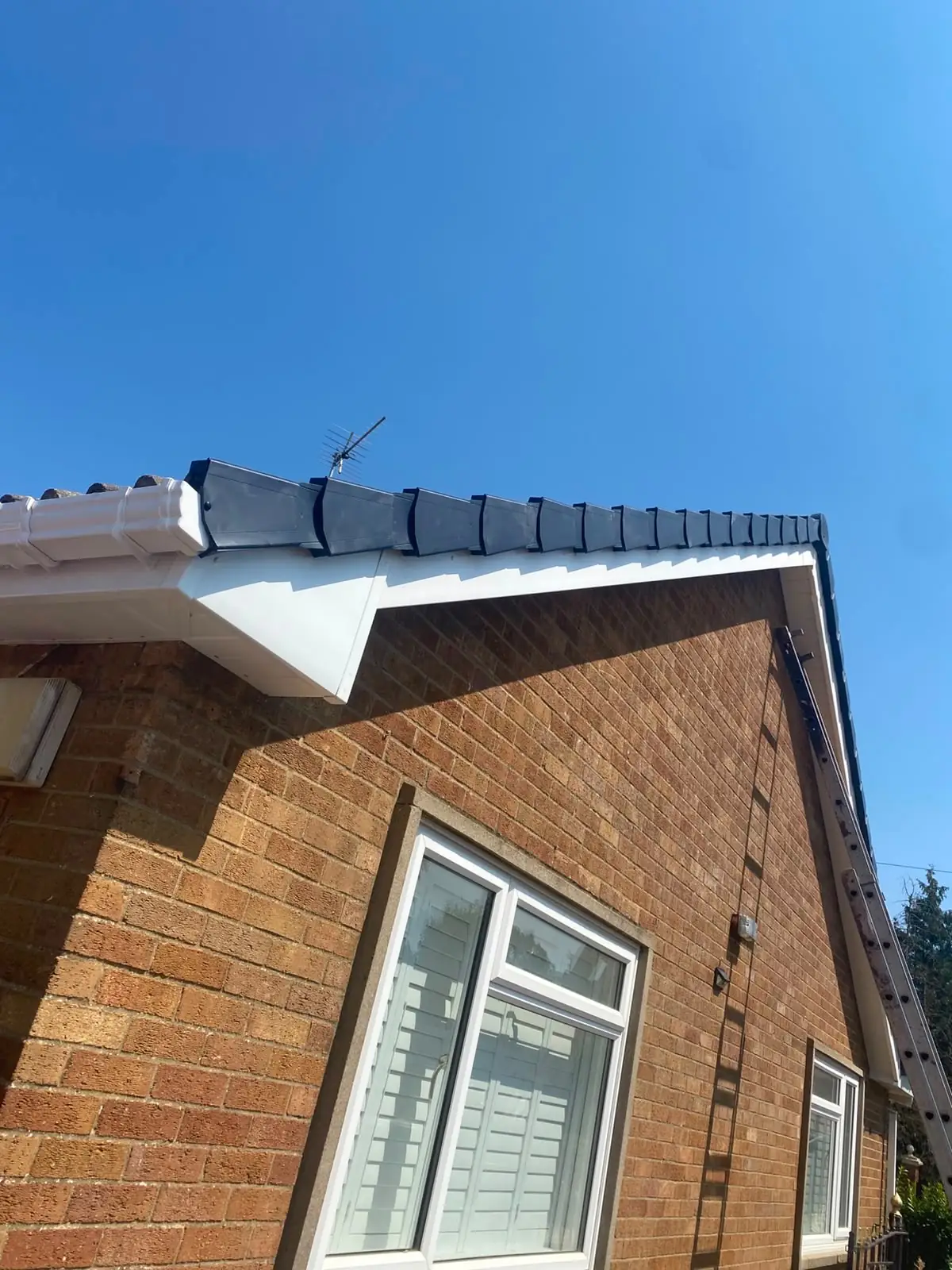 A white uPVC soffit and dry verge finished on a yellow brick house