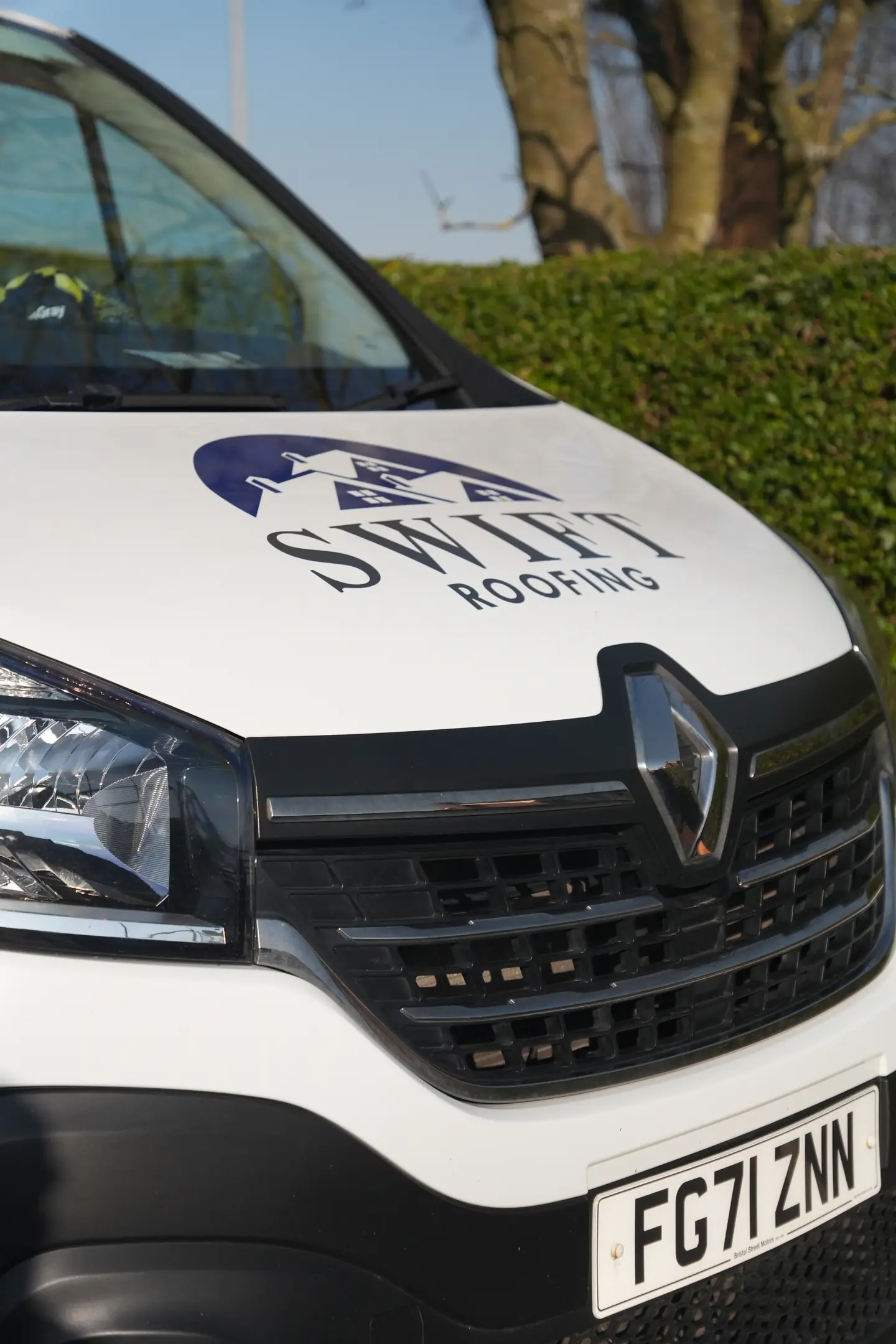The branded Swift Roofing van parked on a Wisbech street