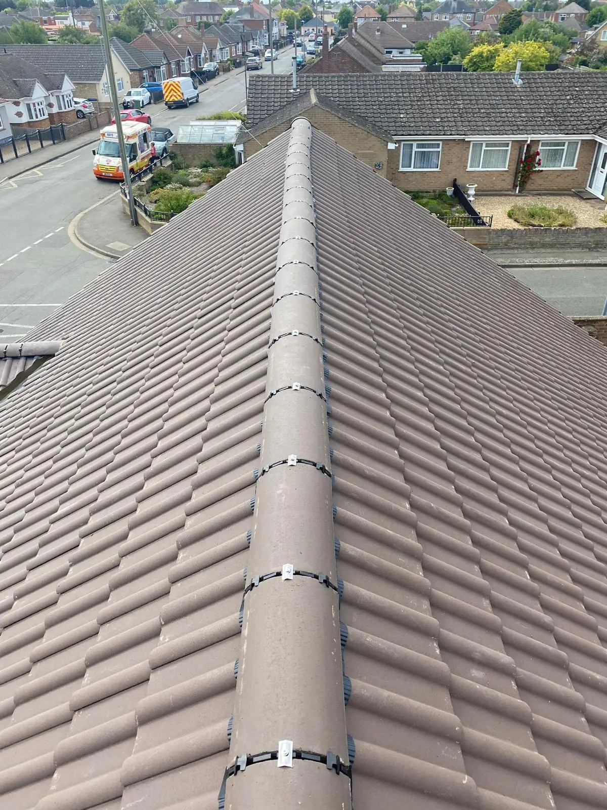 A new ridge line running the length of a finished concrete tiled roof
